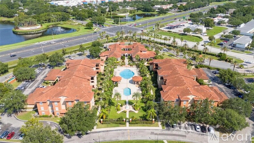 A bird's eye view of a resort with a swimming pool in the center.
