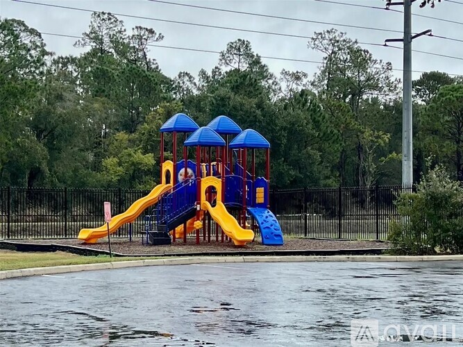 A playground with a blue and yellow slide.