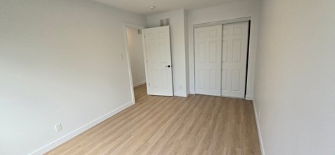 A room with a white door and a white wall.