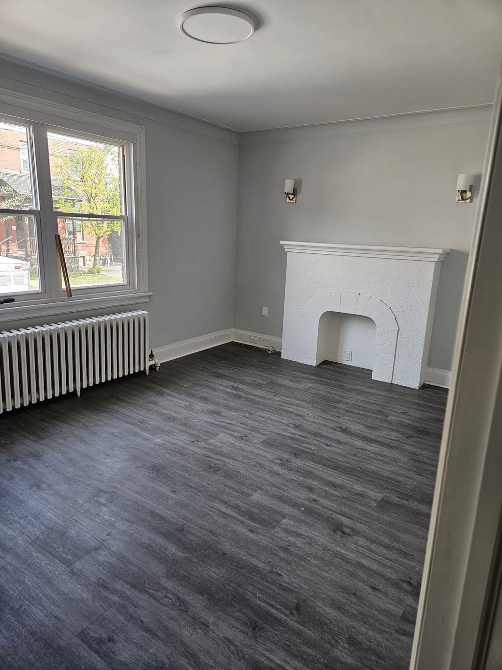 A room with a fireplace and a window.