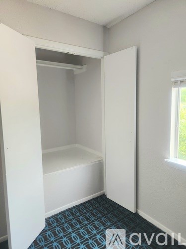 A small room with a window and a bathtub.