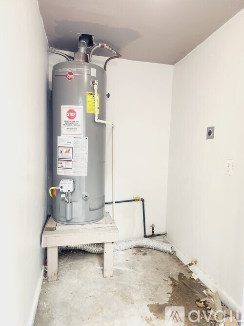 A water heater with a stop sign on it.