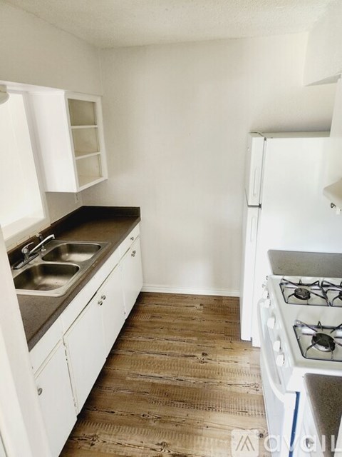 A kitchen with a stove and sink.