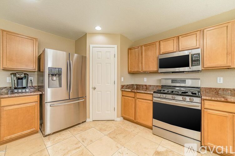 A kitchen with wooden cabinets and stainless steel appliances.