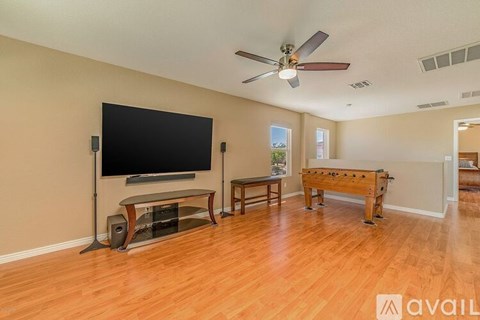 A room with a television, a bench, and a pool table.