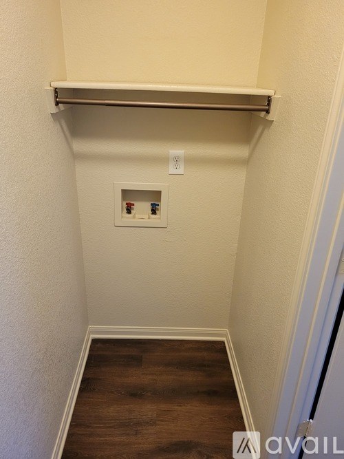A small room with a shelf and a light switch.