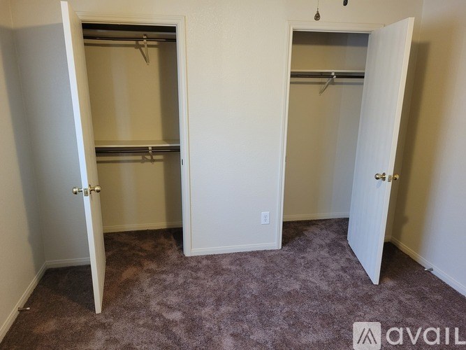 Two open closets with shelves and doors.