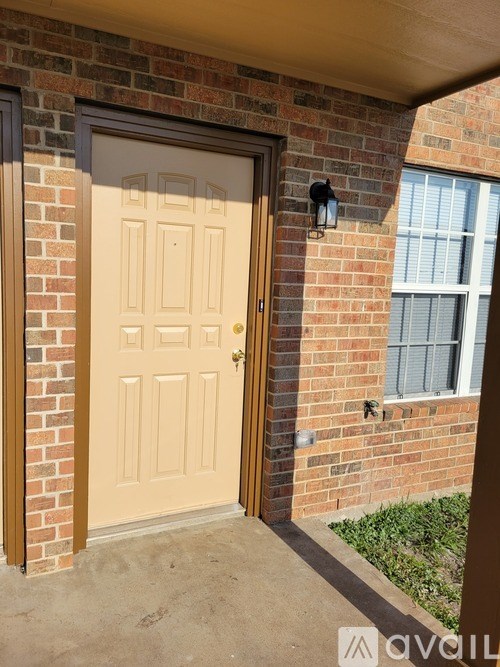 A beige door is closed and has a black handle.