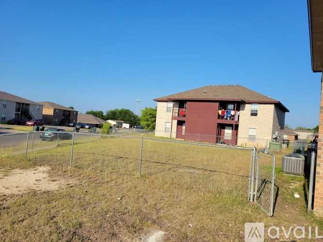 A fenced-off area with a building in the background.