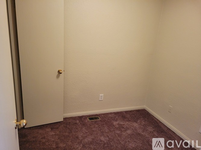A room with a door and a carpet on the floor.