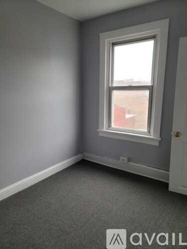 A room with a window and a door.