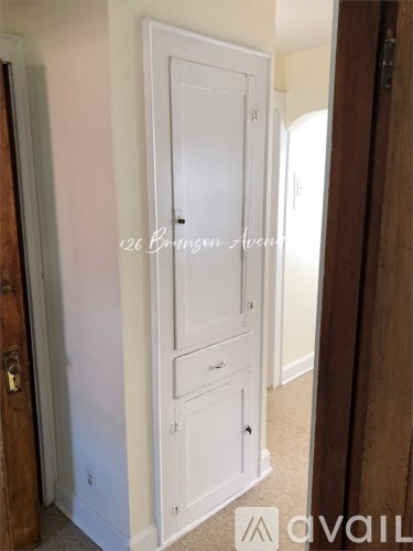 A white door with a handle and a lock.