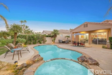A house with a pool in the backyard.