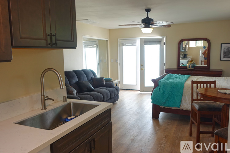 A kitchen with a sink and a ceiling fan.