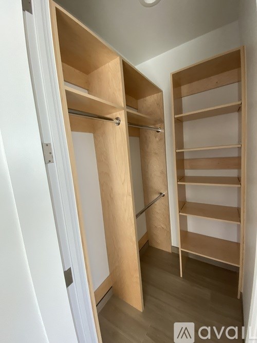 A wooden closet with shelves and a hanging rod.