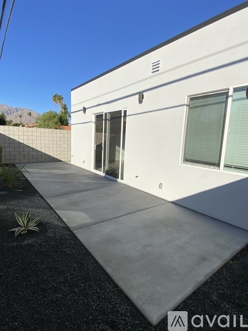 A modern house with a white exterior and a glass door.