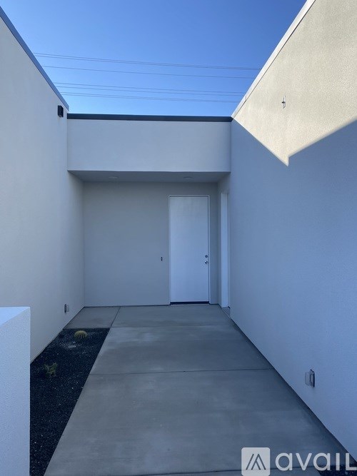 A narrow alley with a door at the end.