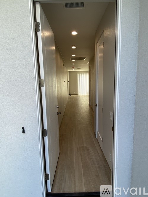 A long hallway with doors on both sides.
