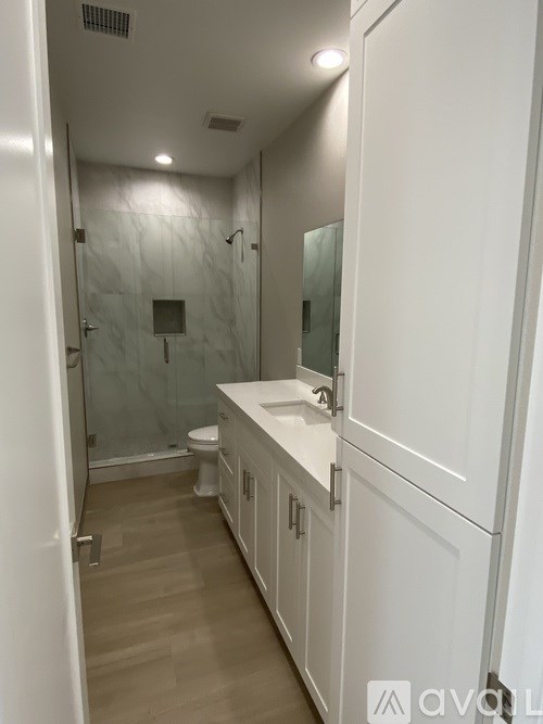 A bathroom with a walk-in shower and a toilet.