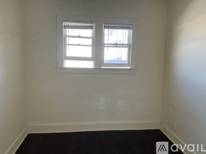 A room with a window and a sign that says "AVAIL".