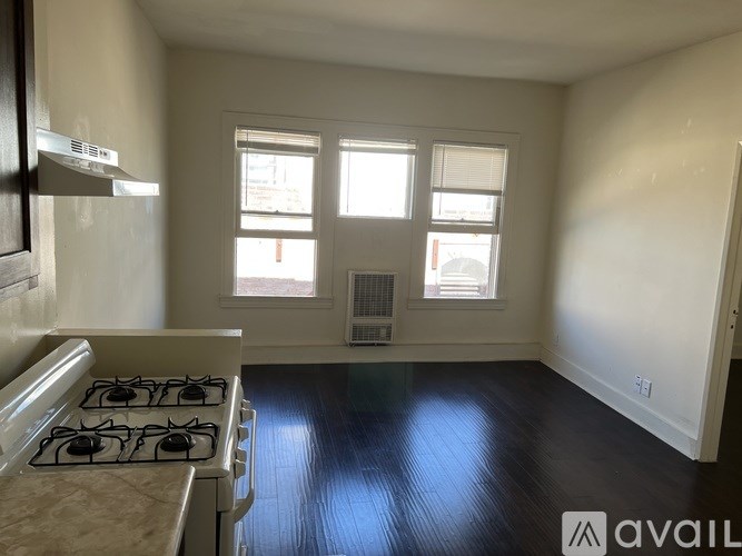 A kitchen with a stove and a window.