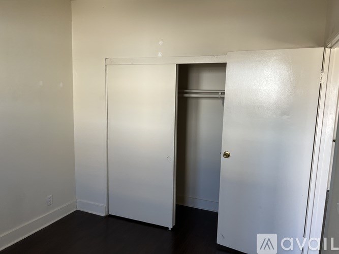 A white door is in a white room.