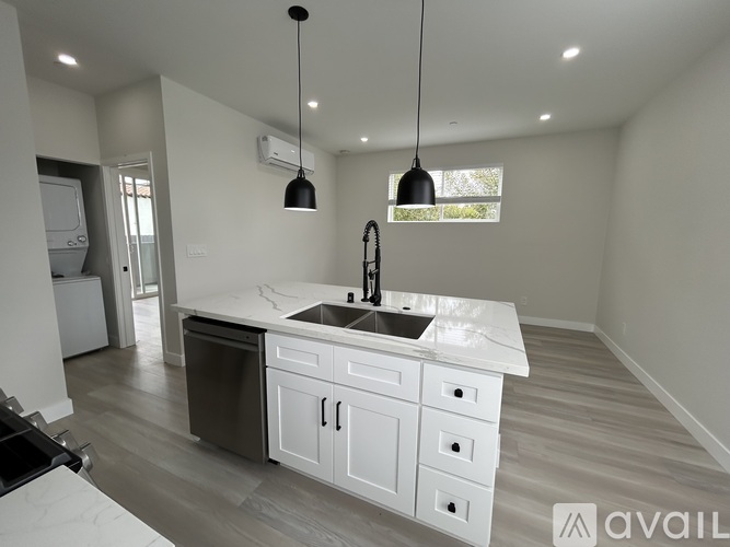 A modern kitchen with a large island and a dishwasher.