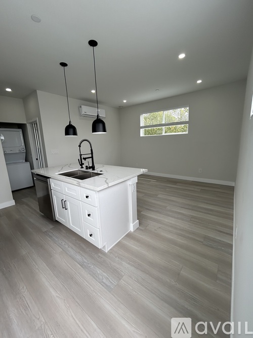 A kitchen with a sink and a window.