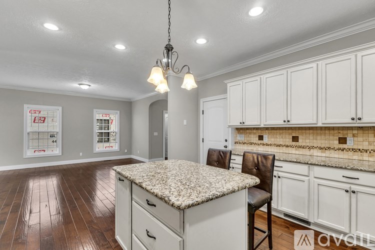 A living room with a blue couch and a fireplace.