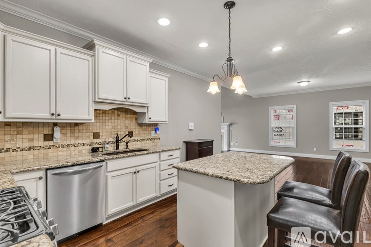 A living room with a blue couch and a fireplace.