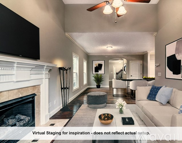 A bedroom with a bed, a ceiling fan, and a window overlooking a garden.