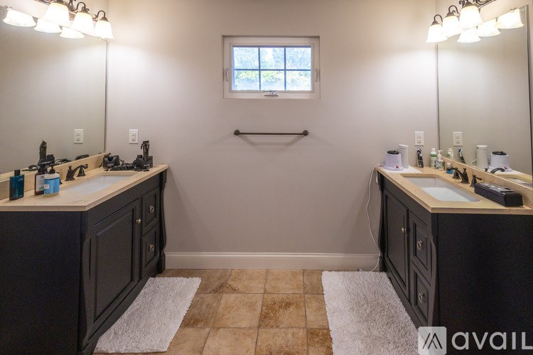 A bathroom with a marble countertop and a large mirror.