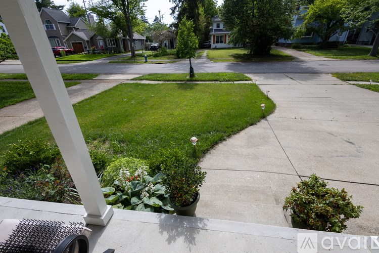 A view of a residential street from a porch.