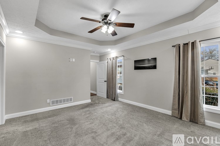 A bathroom with a tub and a window.
