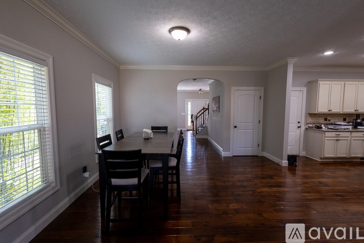 A kitchen area with a dining table and chairs.