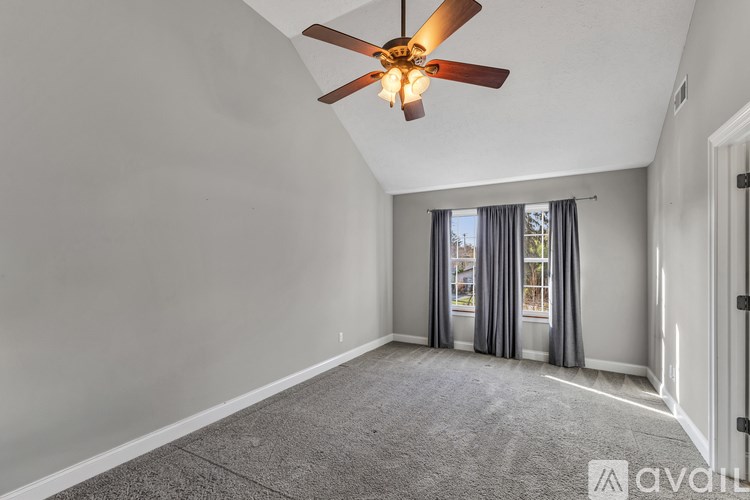 A bathroom with a toilet, sink, and window.