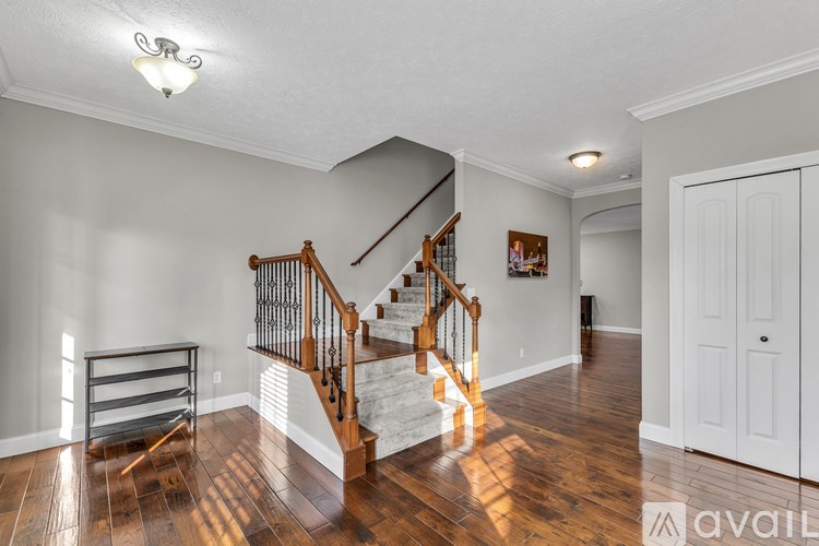 A house with a brown roof and a small patio with a table and chairs.
