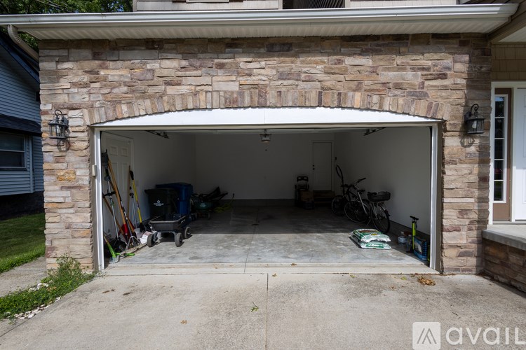A garage with a stone wall and a white door.