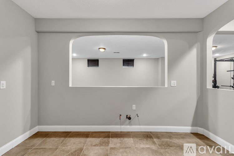 A room with a blue yoga mat and a mirror on the wall.