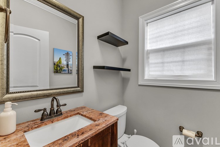 A garage with a bicycle leaning against the wall and a few items scattered around.