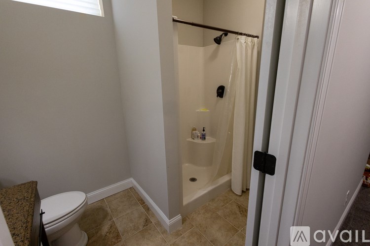 A bathroom with a toilet, a tub, and a shower.