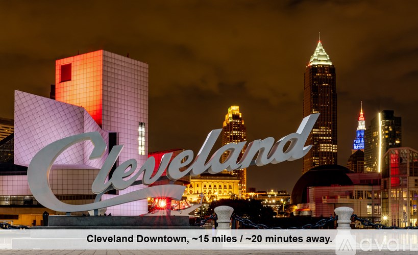 A nighttime view of Cleveland Downtown with the skyline illuminated and the word "Cleveland" prominently displayed.