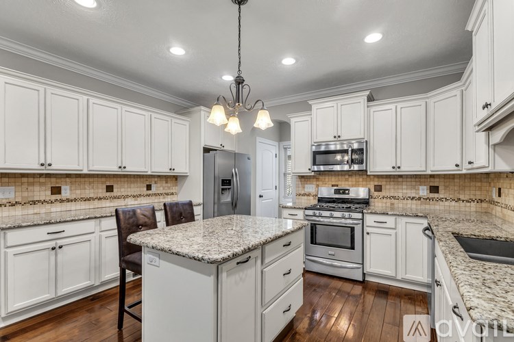 A well-lit kitchen and dining area with a wooden table and chairs.