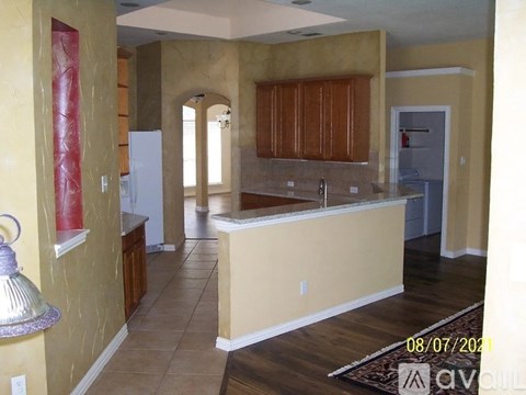 A kitchen with wooden cabinets and a white refrigerator.