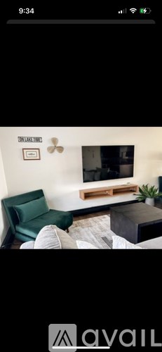 A living room with a green couch and a wooden coffee table.