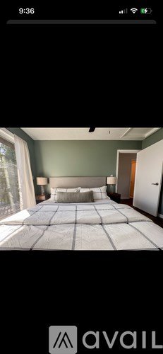 A bedroom with a large bed and a window.