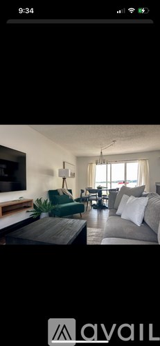 A living room with a grey couch and a green armchair.