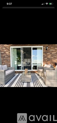 A patio with a couch, table, and chairs is shown.