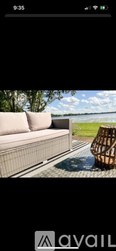 A modern outdoor seating area with a woven chair and a white sofa.