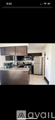 A modern kitchen with stainless steel appliances and cabinets.